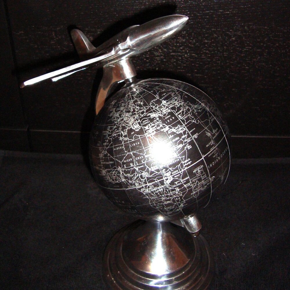 globe with aircraft flying overtop